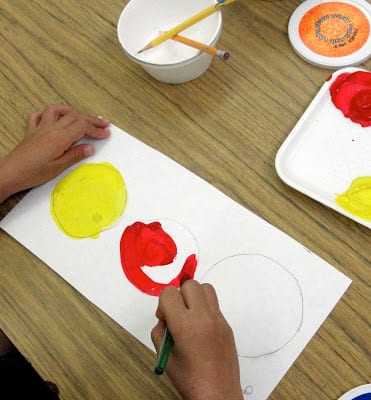 Colorwheel flowers spring art lesson using primary colored tempera paints