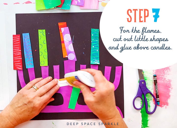 making a paper menorah cut out shapes for flames and glue about candels